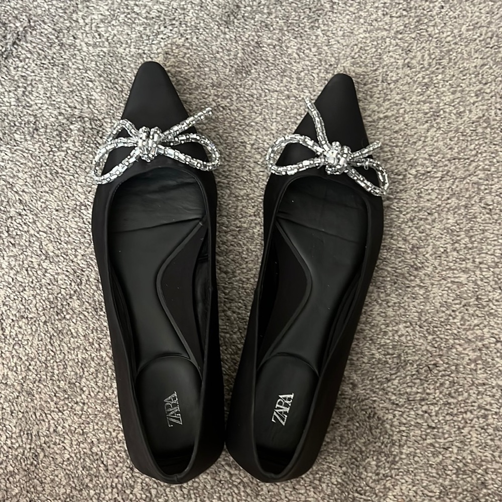 Black flat shoes. Silver bow adds the sparkle.
